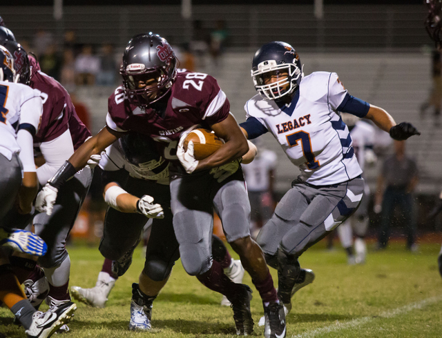 Cimarron-Memorial’s Tyree Riley carries the ball in the first half against Legacy on S ...