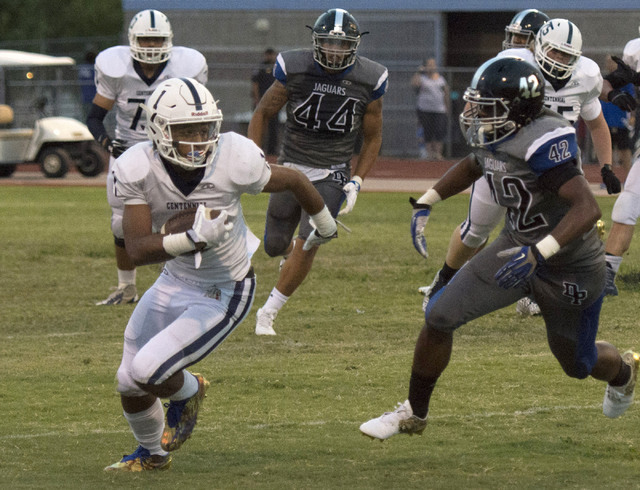 Centennial High School’s Bryce Hampton (1) runs the ball upfield during a football gam ...