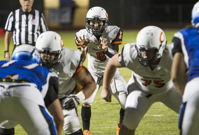 Chaparral quarterback Santiago Vialpando (8) hikes the ball against Basic players during a v ...