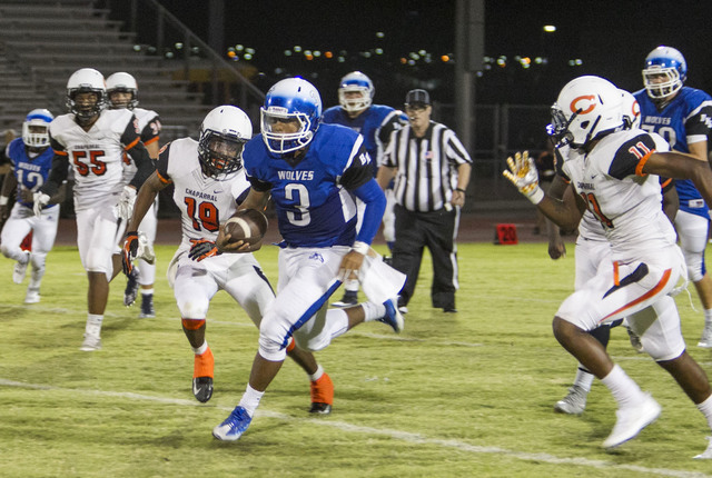 Basic’s quarterback Aaron Mcallister (3) runs the ball against Chaparral players during a ...