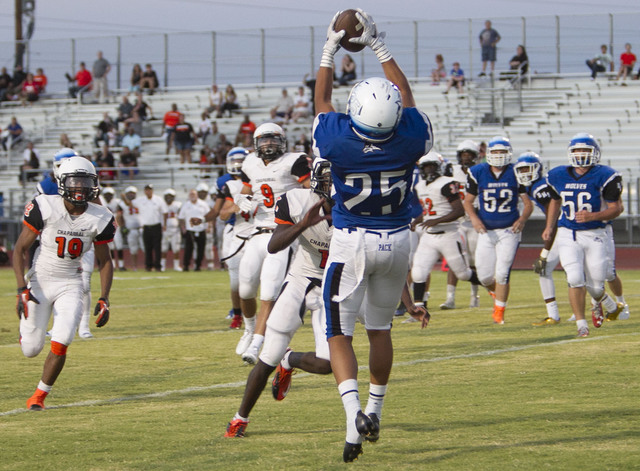 Basic’s Jordan Gallegos (25) catches the ball for a touchdown against Chaparral playe ...