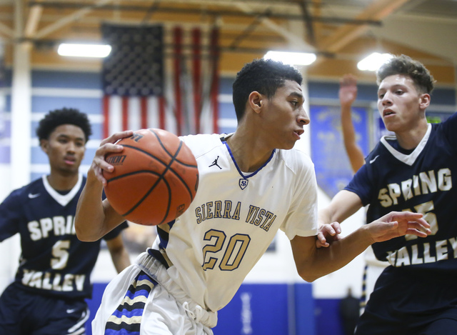 Sierra Vista guard Mathias Aaiva (20) drives against Spring Valley during a basketball game ...