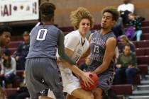 Cimarron-Memorial’s Keiron Hatchett (0) and Kamakana Winquist (13) defend Faith Luther ...