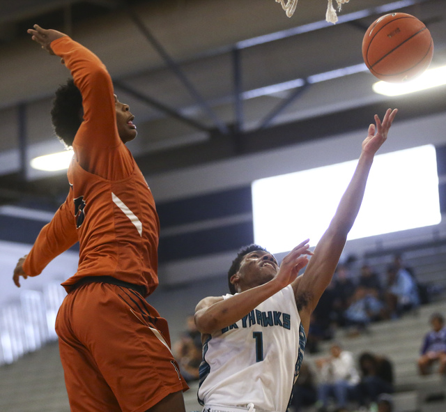 Legacy’s Chris White (5) tries to block a shot from Silverado’s Dajon Keeling (1 ...