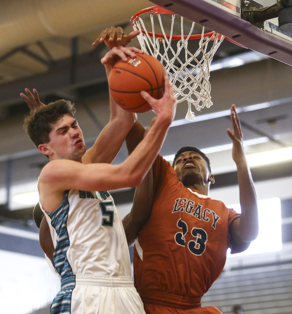 Silverado’s Caden Farley (5) and Legacy’s Joseph Carter (33) fight for a rebound ...