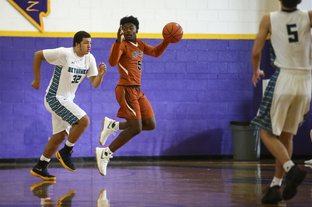 Legacy’s Chris White (5) drives past Silverado’s Devin Ross (32) during a basket ...