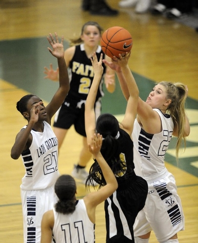 Spring Valley guard Jessica Rafay, right, blocks a shot attempt by Faith Lutheran point guar ...