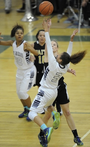 Spring Valley guard Essence Booker (3) goes up for a layup against Faith Lutheran’s Mo ...