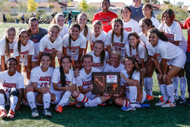 Arbor View’s girls soccer team poses with their plaque after winning the Sunset Region ...