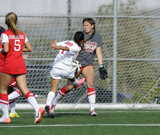 Coronado goalkeeper Rachel Morris, center, makes a save against Arbor View midfielder Sierra ...