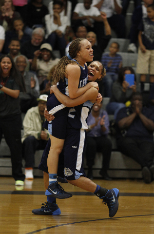 Centennial’s Teirra Hicks lifts teammate Tramina Jordan in celebration after the Bulld ...