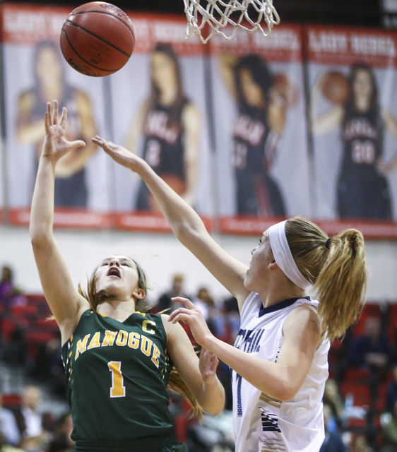 Bishop Manogue guard Katie Turner (1) shoots to score over Foothill’s Kylie Vint (11) ...
