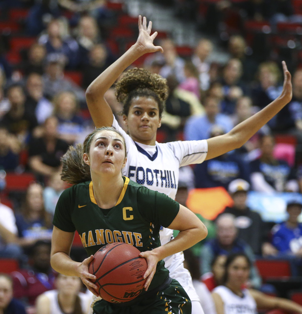 Bishop Manogue guard Malia Holt (5) drives to the basket against Foothill during the Class 4 ...