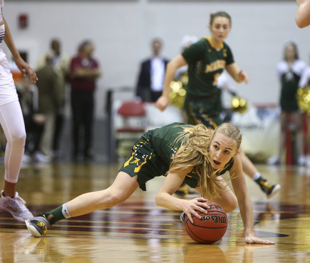 Bishop Manogue guard Kenna Holt (11) reaches out to keep control of the ball during the Clas ...