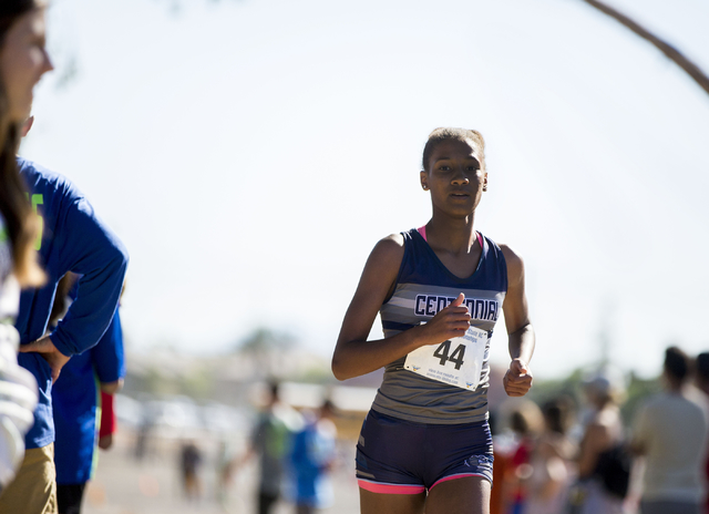 Centennial junior Alexis Gourrier leads the pack of runners on the second lap of the 3.1 m ...