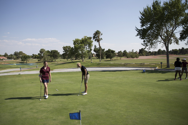 Faith Lutheran’s Olivia Vogel,17, left and Sydney Smith, 16, practice at the Palm Vall ...