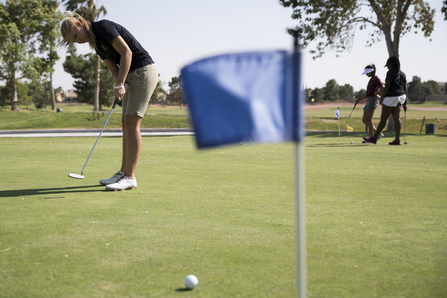 Faith Lutheran’s Sydney Smith, 16, hits a putt during a team practice at the Palm Vall ...