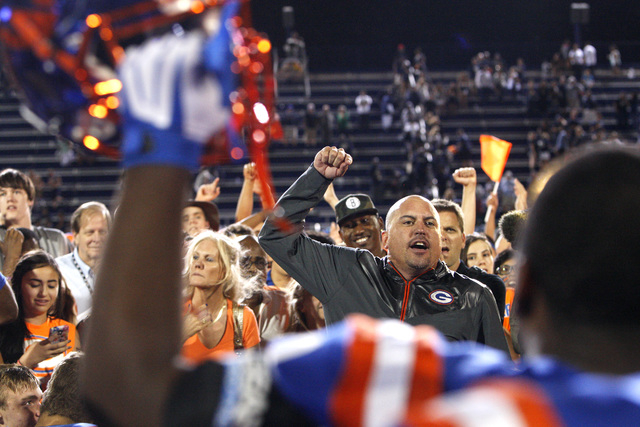 Bishop Gorman coach Tony Sanchez and his players celebrate defeating St. John Bosco, 34-31, ...