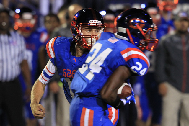 Bishop Gorman quarterback Tate Martell hands off to halfback Russell Booze during their game ...