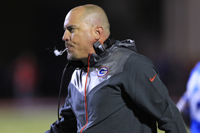 Bishop Gorman head coach Tony Sanchez watches the action during their game against St. John ...