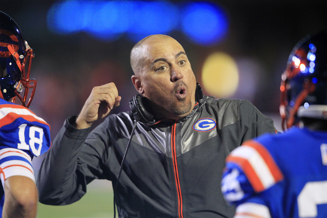 Bishop Gorman head coach Tony Sanchez talks to his players during their game against St. Joh ...