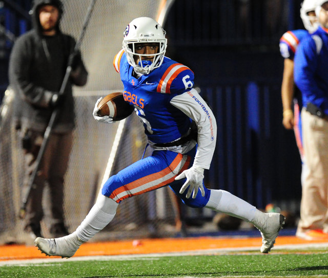 Bishop Gorman receiver Austin Arnold looks for running room after catching a flea-flicker pa ...