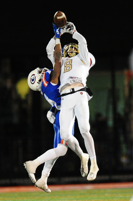 Bishop Gorman coronrback Alex Perry, left, breaks up a pass intended for Faith Lutheran wide ...