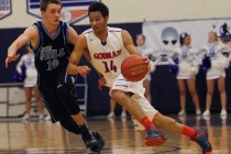 Bishop Gorman senior point guard Noah Robotham (14) drives against Foothill’s Vincent ...