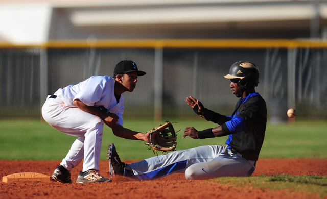 Basic base runner J.J. Smith steals second base while Silverado second baseman Alex Grafiada ...