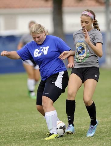 Green Valley girls soccer player Stephanie Chiasson, left, passes the ball in front of Alexi ...
