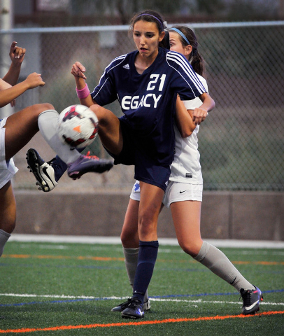 Legacy High School’s Nadia Hernandez (21) is double teamed by Bishop Gorman defenders ...