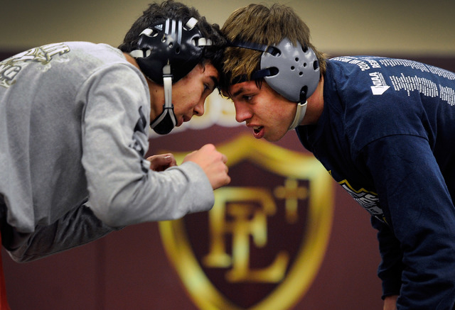 Faith Lutheran wrestler Owen Lawrie, right, goes head-to-head with teammate Hale Enos during ...