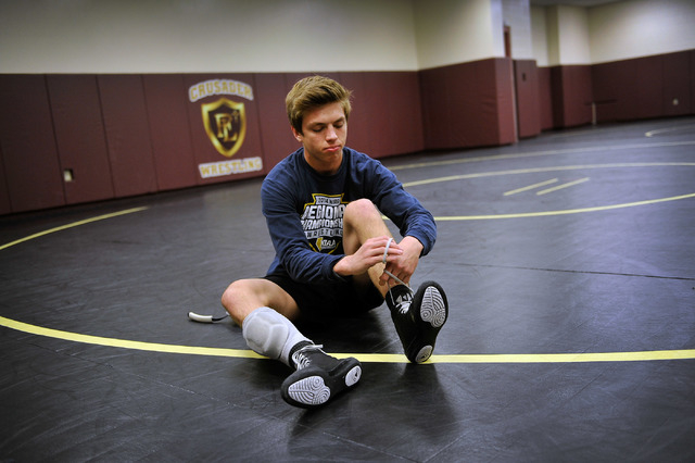Faith Lutheran wrestler Owen Lawrie laces up his boot before practice at Faith Lutheran High ...