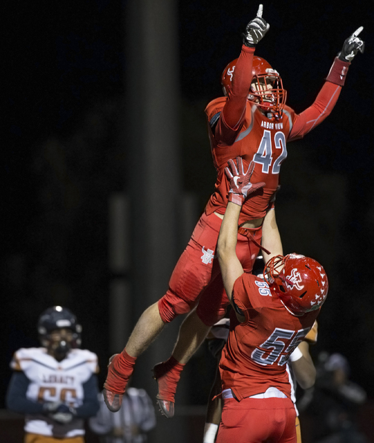 Arbor View’s Andrew Wagner (42) celebrates with Cristian Taylor (55) after scoring a f ...