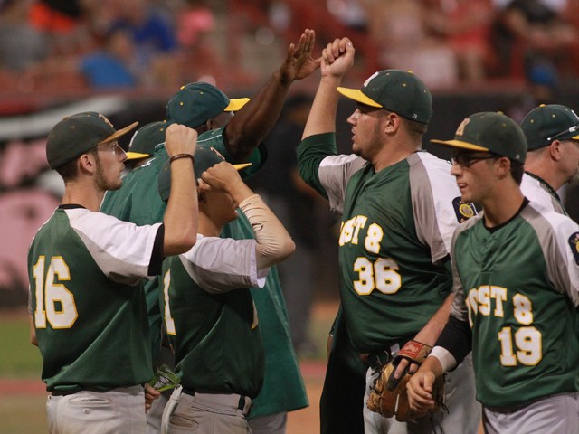 Rancho players high five each other between innings while playing againstBishop Gorman durin ...