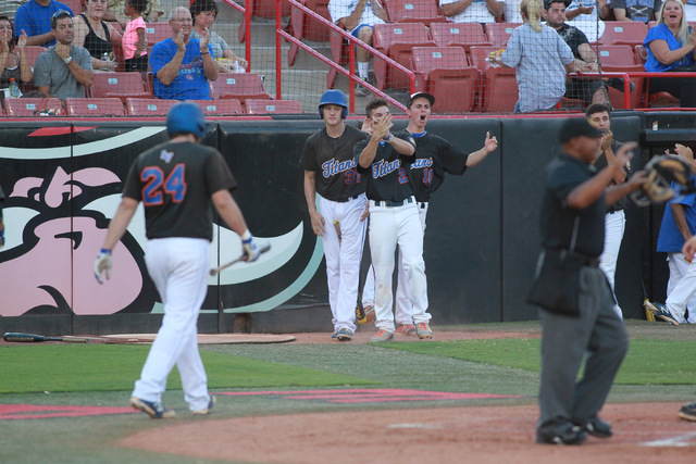 Bishop Gorman players celebrate after teammate Grant Robbins, not pictured, scores a run aga ...