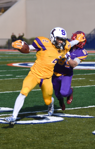 Sunrise Region running back Bobby Merritt (2) fights off team Sunset defender Mitchell Durke ...