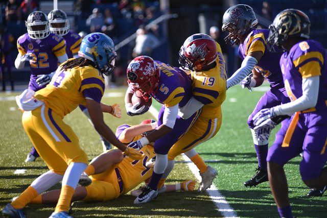 The Sunset Region’s Maurice Harvey (5) is tackled by Sunrise defender Myles Holland (1 ...