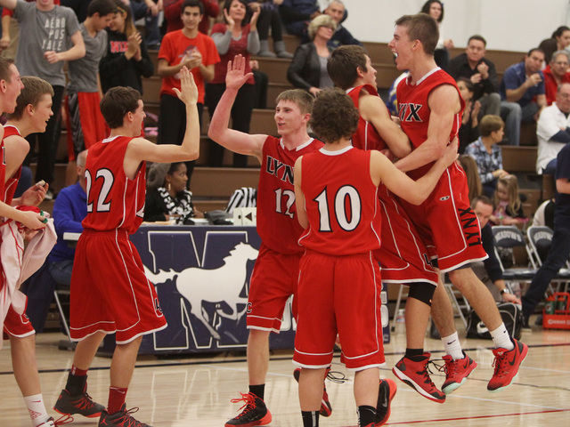 Lincoln County players celebrate after beating The Meadows 81-72 in overtime Saturday at Th ...