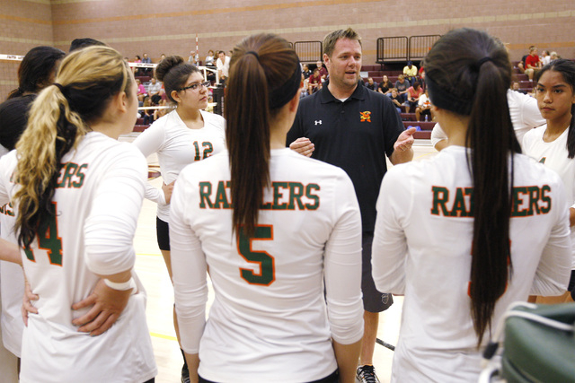 Mojave girls volleyball coach Erik Davis talks to his players between sets against Faith Lut ...