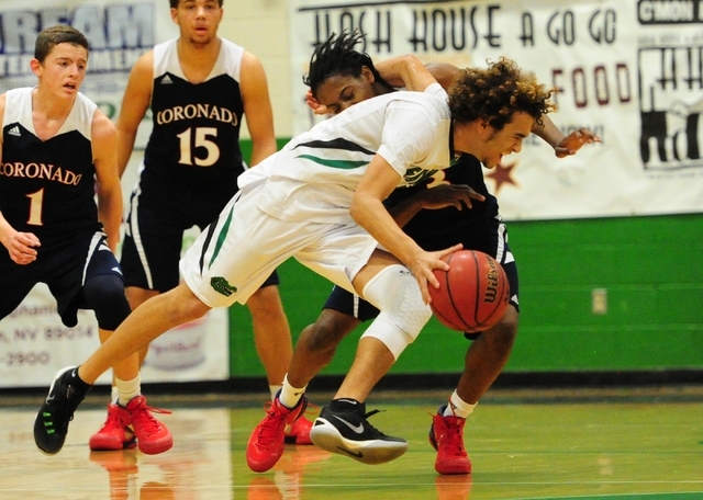 The arm of Green Valley guard Xavier Jarvis gets caught around the neck of Coronado guard Ni ...