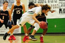 The arm of Green Valley guard Xavier Jarvis gets caught around the neck of Coronado guard Ni ...