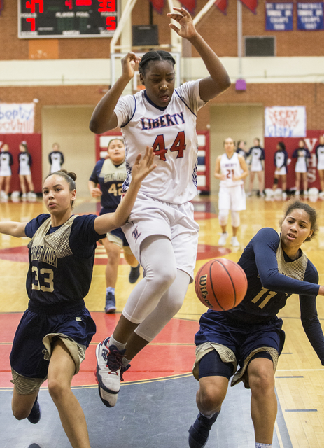 Liberty’s Dre’una Edwards (44) fights for a loose ball with Spring Valley’ ...