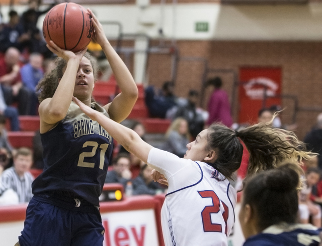 Spring Valley’s Ella Zanders (21) shoots a jump shot over Liberty’s Kaily Kaimik ...