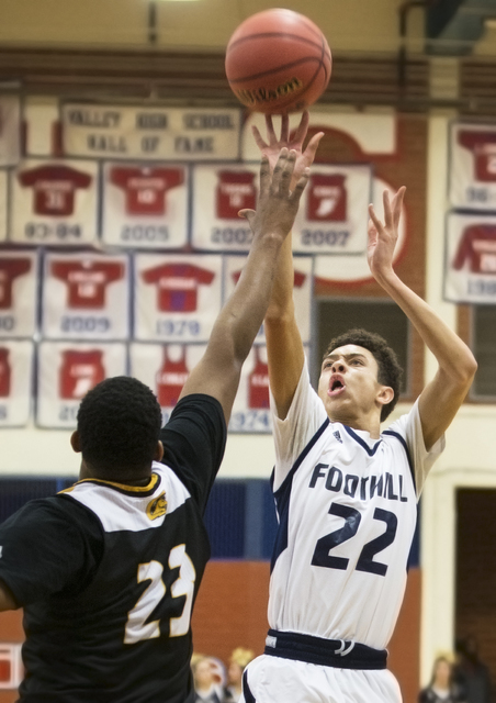 Foothill’s Jace Roquemore (22) shoots a contested three point shot over Clark’s ...