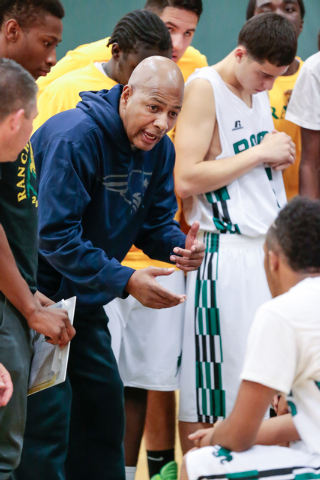 Rancho High School coach Ronald Childress talks with his players during a timeout during a g ...