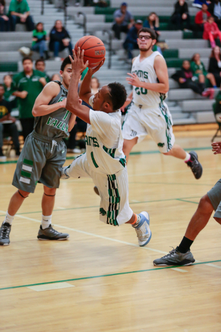 Rancho High School’s David McKeever (1) takes an off-balance shot against Green Valley ...