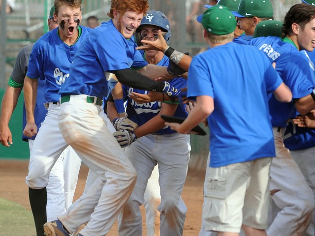 Green Valley’s Keaton Smith, red hair, celebrates with his teammates after he hit a ga ...