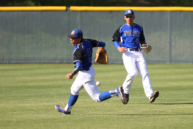 Basic’s Cory Wills (2) misses a fly ball in the outfield with Logan Green (4) in the s ...