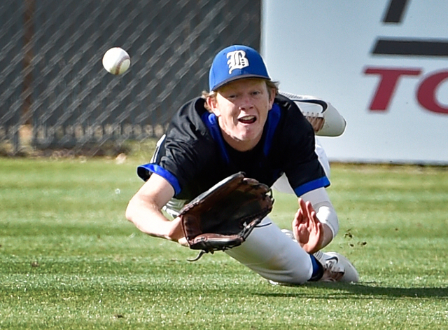Basic outfielder Tanner Roundy dives for the ball during a high school baseball game against ...